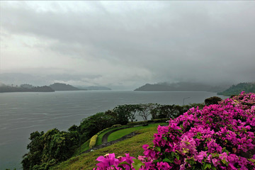 Melancholy. Rain and fog on the lake. Gloomy sky, dark low clouds, mountains in the distance. A...