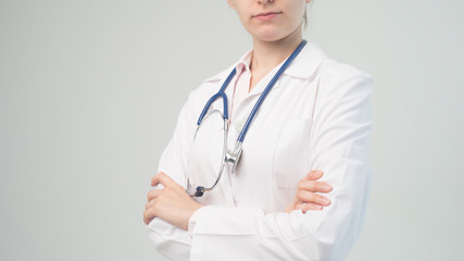 Portrait of an attractive young female doctor in white coat.