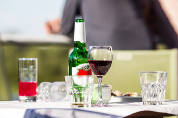 glass of vine and beer bottle