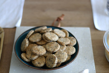 Bowl of healthy spelt flour crackers, served on a table. Selective focus.
