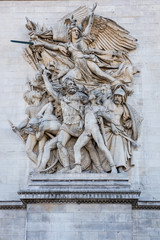 Obraz premium Statue on the wall of the Arc de Triomphe at the Champs-Elysees Avenue in Paris,