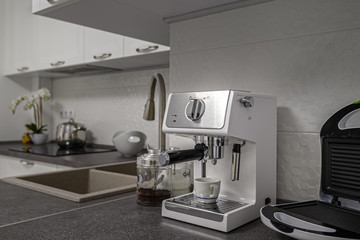 Espresso coffee maker in minimalistic white kitchen interior