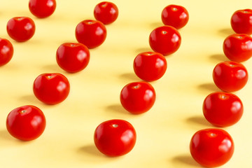 Pattern of red tomatoes on a light yellow background.