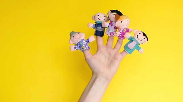 family finger puppet theater. hand with finger puppets: son, daughter,mum, dad, granny, granddad. Kid playing fingers puppets. Family and generation concept. social distancing