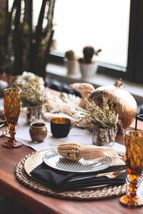 Autumn table with glasses and plates.