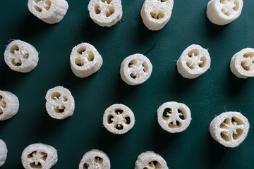 loofah sponge on a green background. flat lay top view
