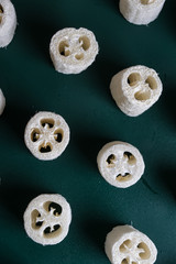 loofah sponge on a green background. flat lay top view