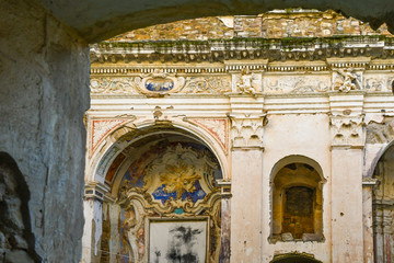 Glimpse of the ruins of the Church of Sant'Egidio, whose bell tower has miraculously escaped the earthquake of 1878 that caused the abandonment of the medieval village, Bussana Vecchia, Imperia, Italy