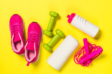 Fitness equipment flat lay image on color background.