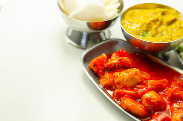 Chinese set,  chicken curry, sweet and sour chicken served with egg fried rice, vegetable spring rolls, and prawn crackers