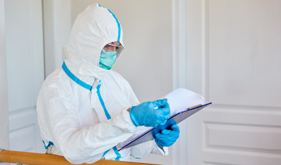 Containment Scout in protective clothing studies visitor list in clinic or nursing home