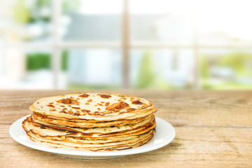 A stack of pancakes on a wooden table