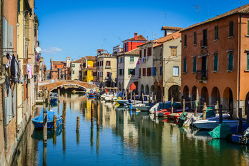 Fototapeta na wymiar Chioggia, town in venetian lagoon, water canal and boats. Veneto, Italy, Europe.