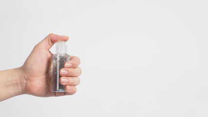 Hands is holding alcohol hand gel on white background.