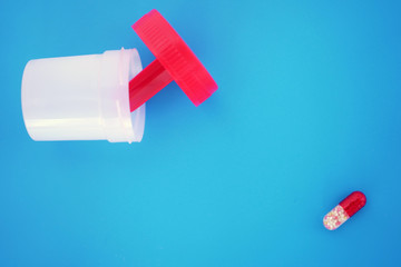 Plastic container, box for testing on an isolated blue, bright background. Delivery of biomaterial.