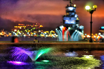 Illuminated fountain in bay of Novorossiysk. Multi-colored illuminated fountain.