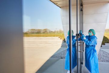 Cleaning staff disinfecting the entrance area of ??a clinic because of Covid-19