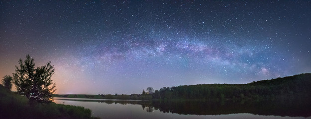 Panorama of the starry sky over the lake