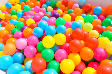 Fototapeta na wymiar Small colorful plastic balls in playground yard