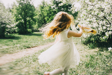portrait of a little red-haired girl in Apple trees