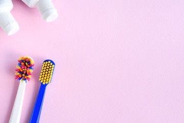 New and used toothbrush, dental floss and toothpaste on neutral pink background, selective focus,...