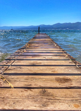 Wooden pier by sea. Boards of the pier and sea waves.
