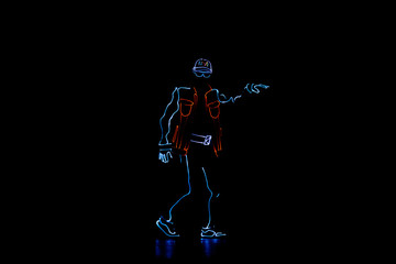 Dancer in suits with LED lamp. Silhouette of a man in a luminous suit on a black background. Neon costume. Entertainment.