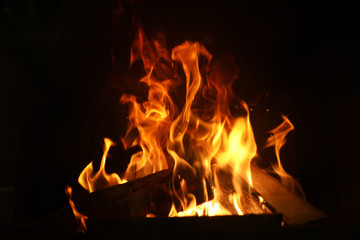 Fireplace with burning wood, closeup view. Winter vacation