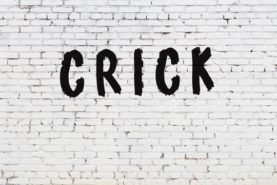 Word crick painted on white brick wall