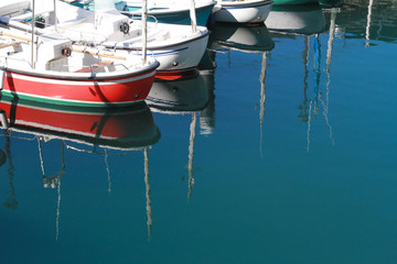 Small Fishing Boats Bows Reflection in San Sebastian Donostia Dock on a Summer Day
