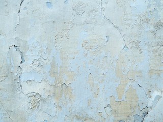 Obraz premium texture of old stucco on the wall. the white and blue plaster is applied unevenly, peeling off. old rough with cracks.