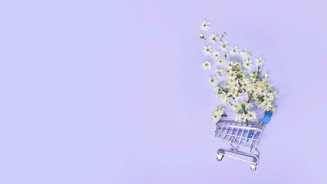 flowers fly out of the shopping cart on a blue background. spring shopping concept. seasonal sale.