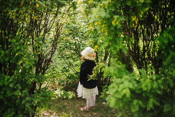 portrait of a little red-haired girl in Apple trees