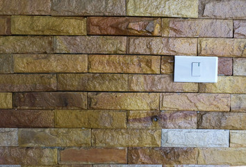 Power plug and swich on or off on old brick wall.