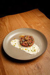 Raw beef meat tartar with mashed potatoes on a side.