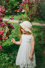 portrait of a little red-haired girl in Apple trees