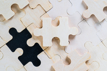 wooden jigsaw puzzle pieces on black background