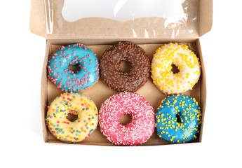 Tasty glazed donuts in cardboard box isolated on white, top view