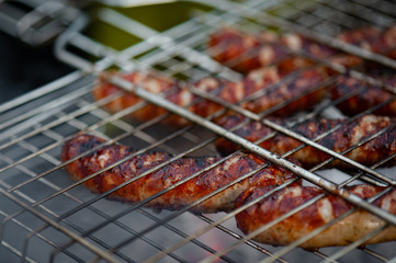 Hot sausage grilling outdoors on a barbecue grill.