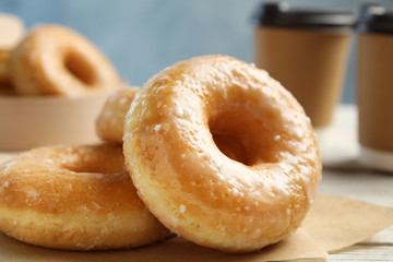 Sweet delicious donuts on table, closeup view
