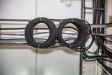 Cable management. Working wires, cables wound into a coil, a circle. Two rings of coiled wires,...
