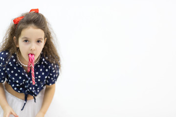 Close up of a girl face with lollipop in the mouth.