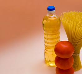 A set of products for cooking pasta. Spaghetti, olive oil, tomatoes. cooking at home, Italian dishes.