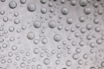 Abstract lines through drops of water on a glass, macro view