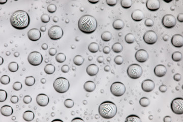 Abstract lines through drops of water on a glass, macro view