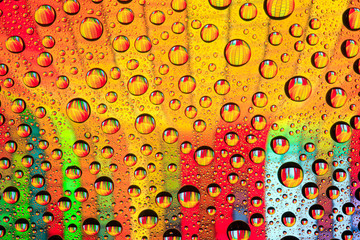 Abstract lines through drops of water on a glass, macro view