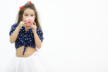 Little model posing for a photo with donut and having fun.