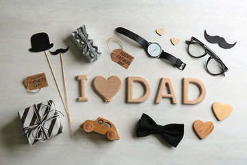 Flat lay composition with phrase I LOVE DAD on white background. Happy Father's day