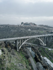 Fototapeta na wymiar stone bridge in the mountains in Armenia in winter in the snow rocks