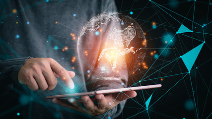 businessman holding digital tablet with Global network connection on screen. Big data analytics and business intelligence concept. World map point and line composition concept of global business.
